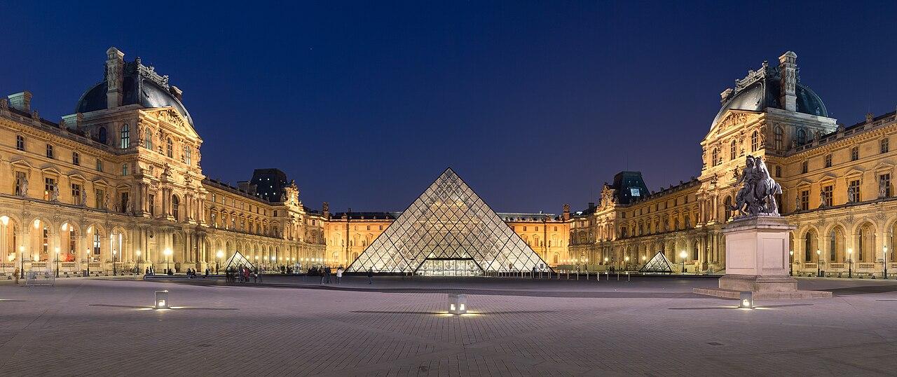 The Louvre palace and glass pyramid in Paris