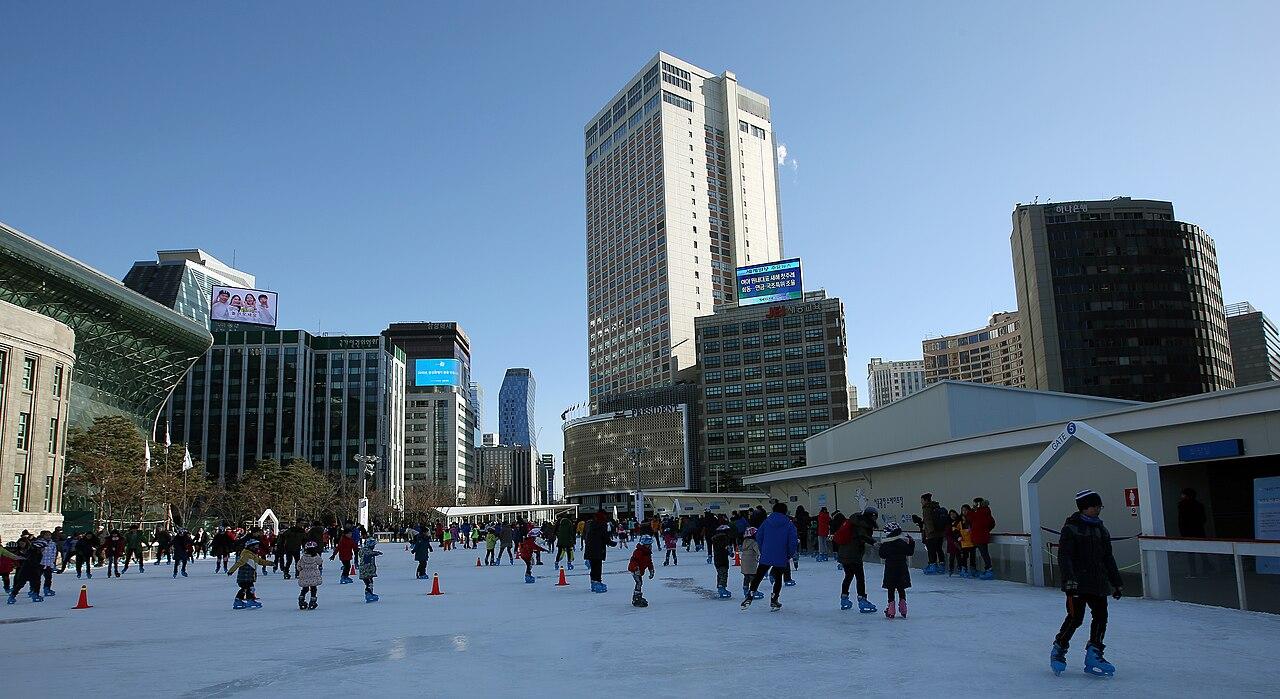 Skaters on the winter ice rink in Seoul Plaza in front of City Hall