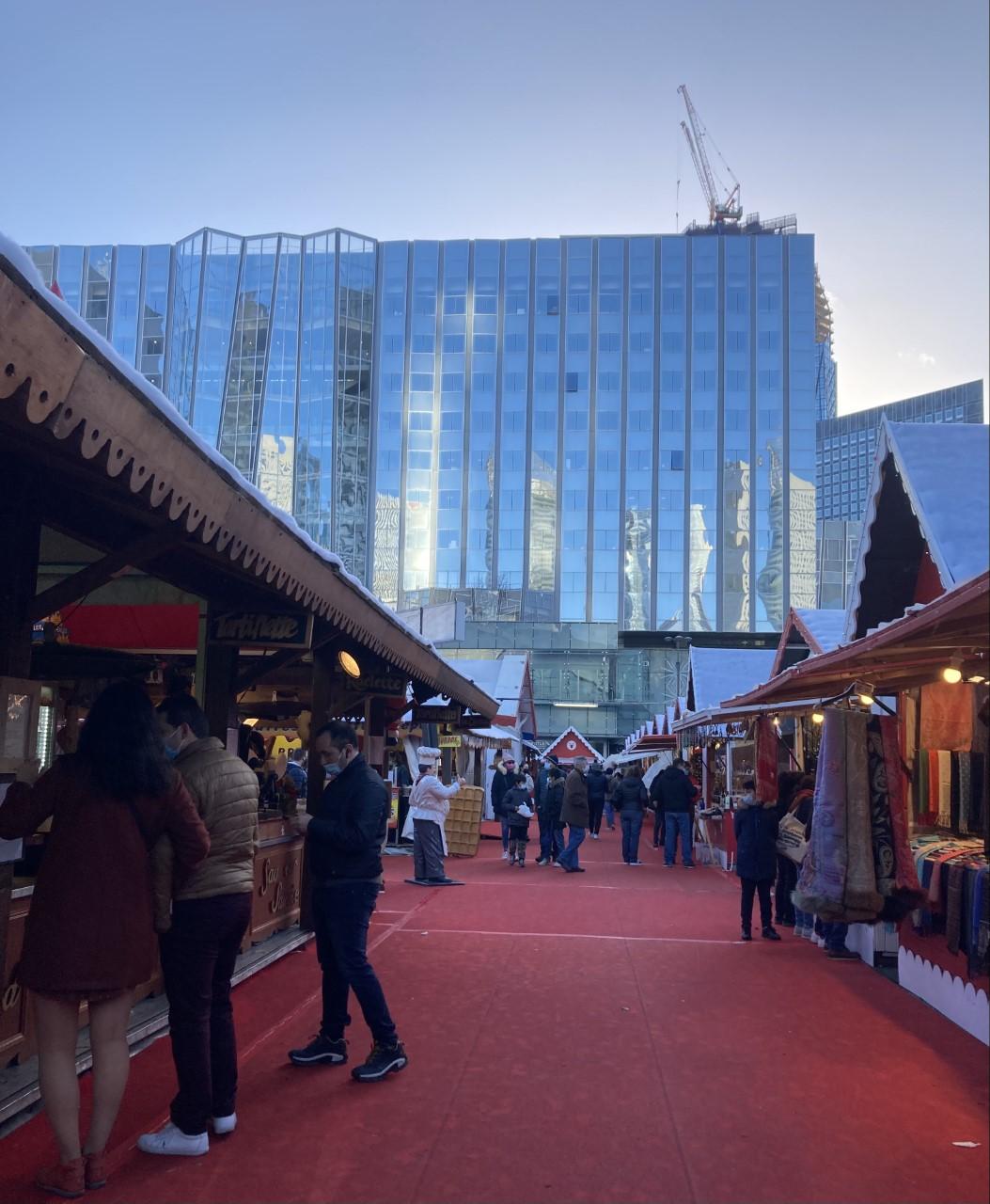 Red-roofed chalets of the La Défense Christmas market below the office towers