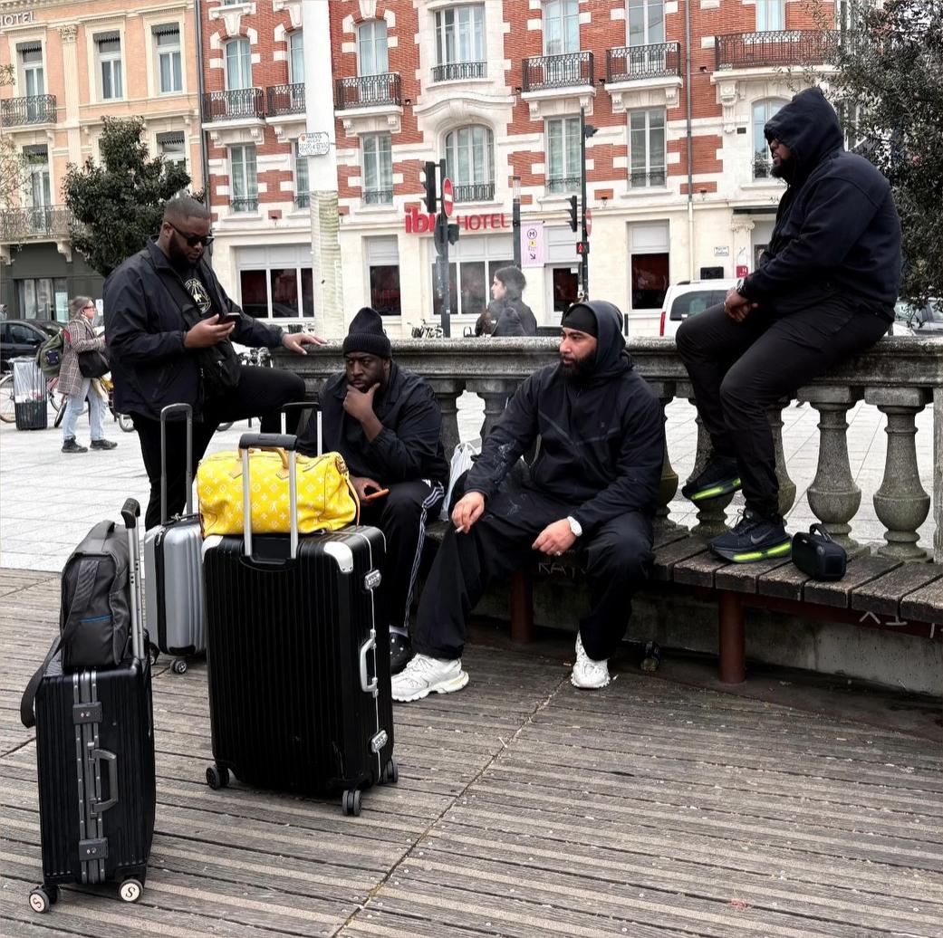 Group of travellers with luggage outside a hotel