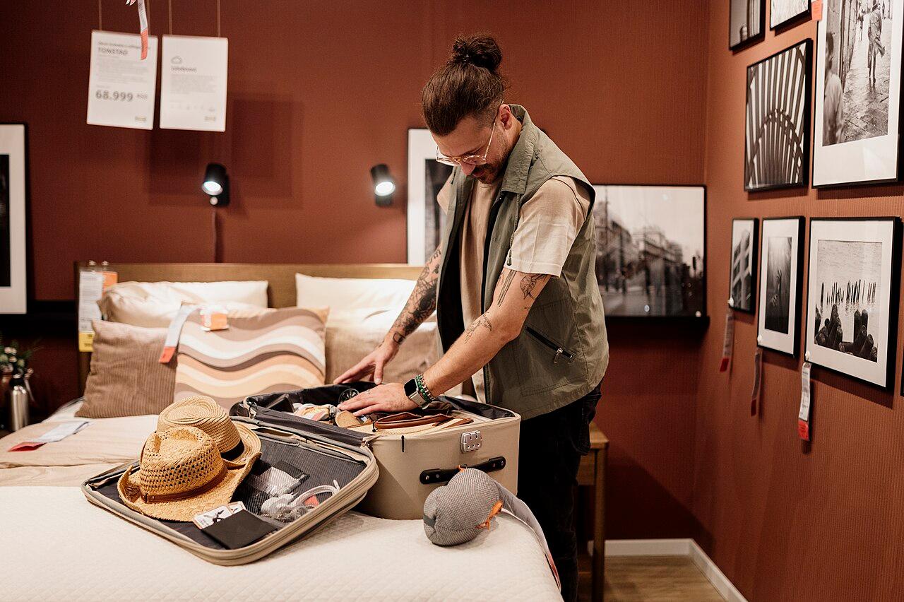 Traveller packing luggage in a hotel room
