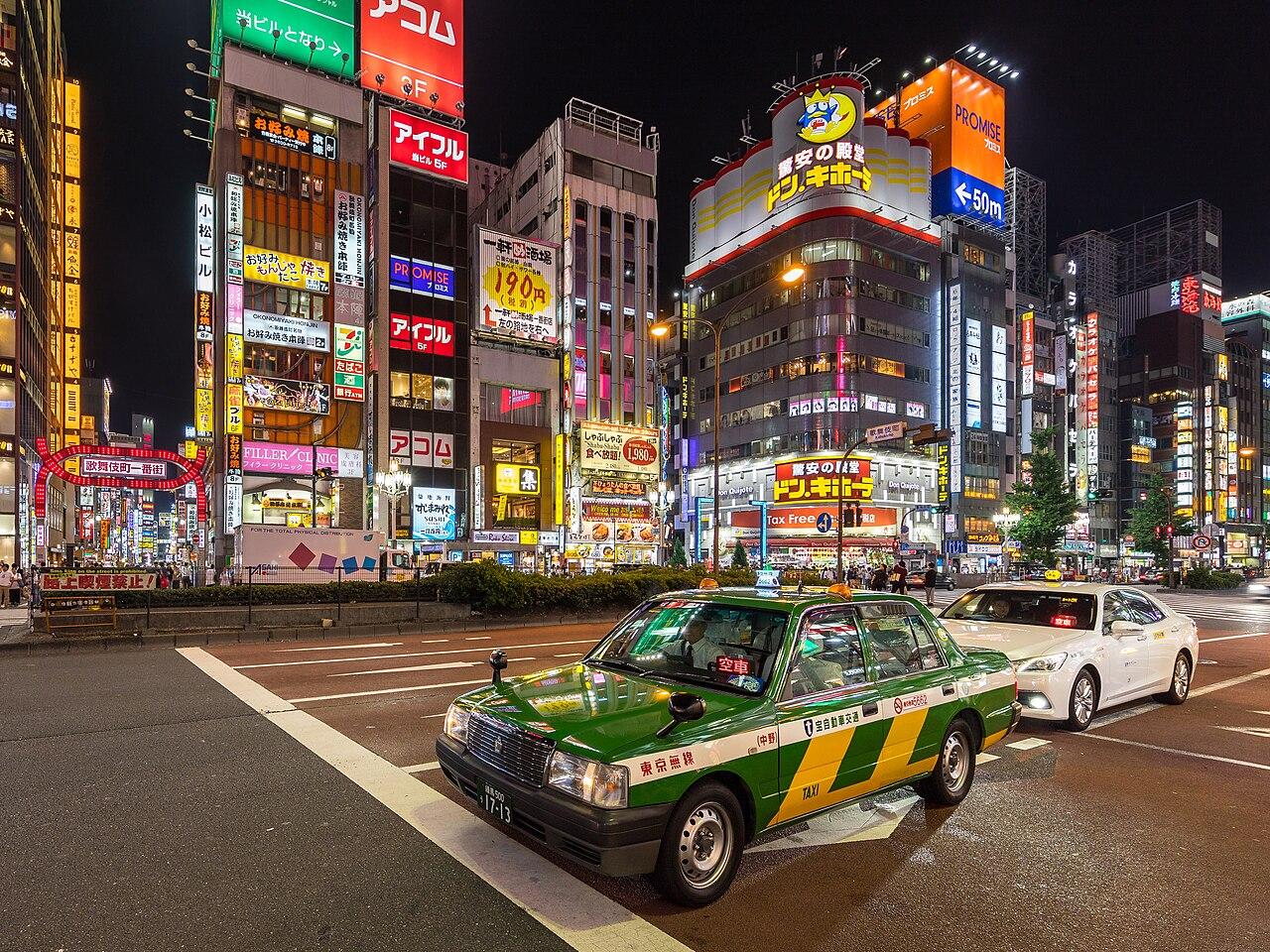 Yasukuni-dori in Shinjuku at night with neon signs and taxis